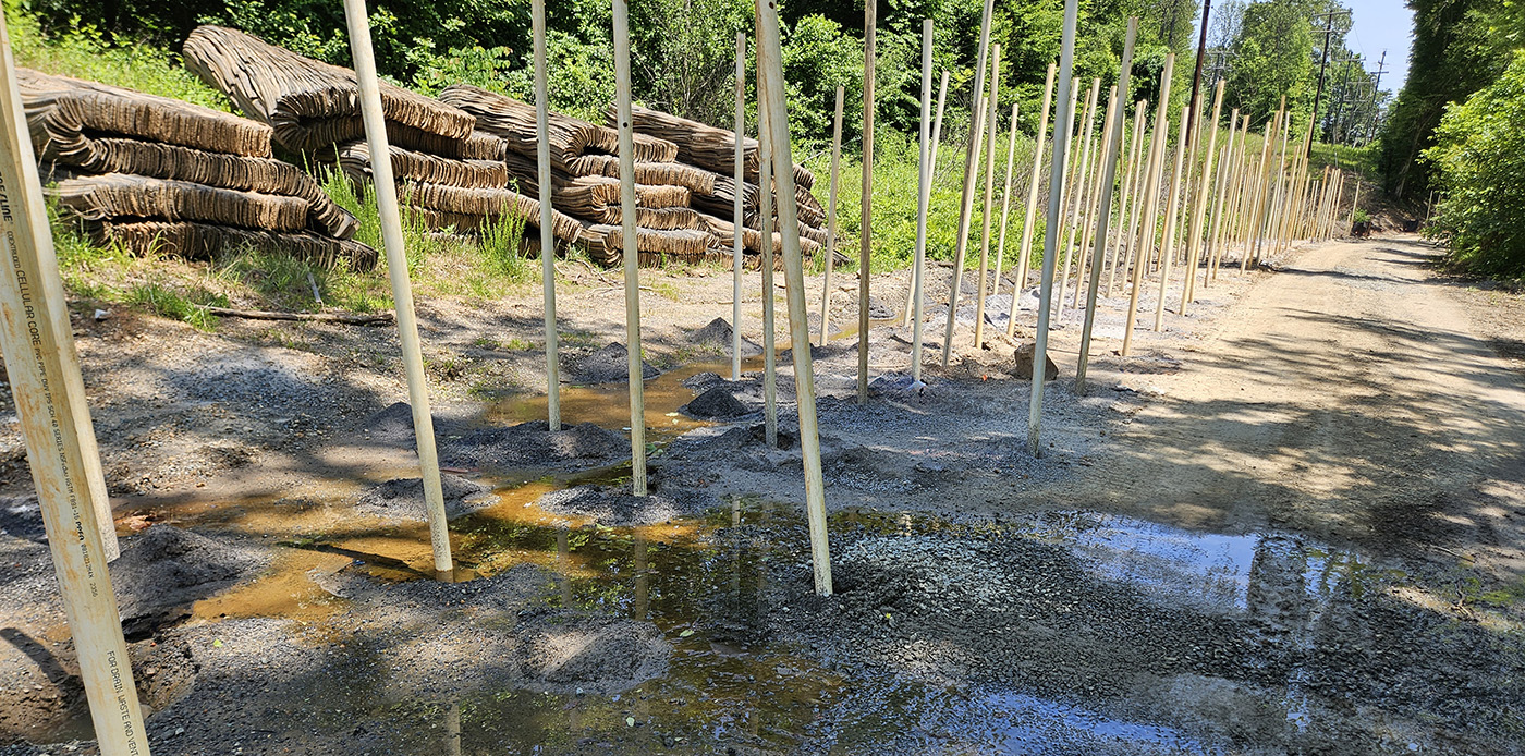 Holes are bored along Old Rio Mills Road in preperation for blasting
