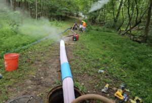 Workers install Cure-in-Place Pipe Lining